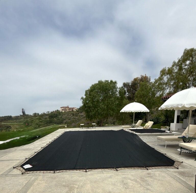 Leaf cover over a freeform pool on a stone deck