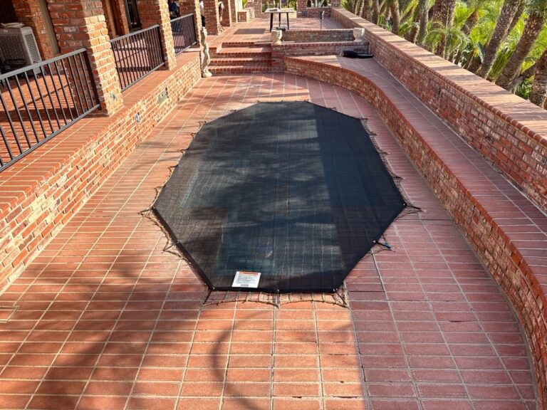 Leaf cover over a long pool on a brick deck