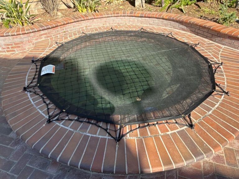 The same spa with a black leaf cover over a net