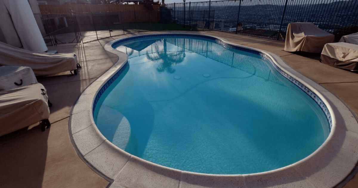 Backyard swimming pool before pool fence install