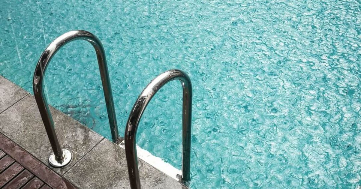 Outdoor swimming pool during a rain storm
