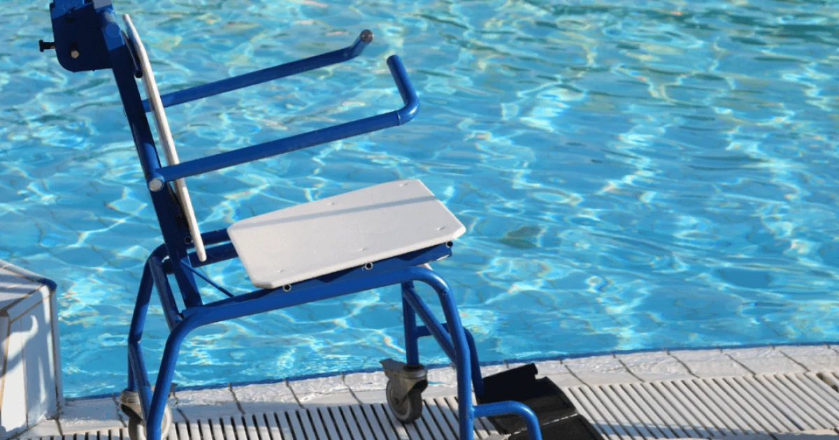 Blue wheelchair sitting beside a swimming pool