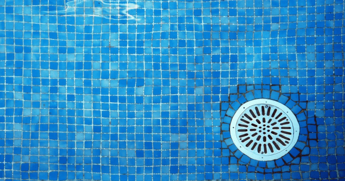 Underwater image in a swimming pool showing a pool drain
