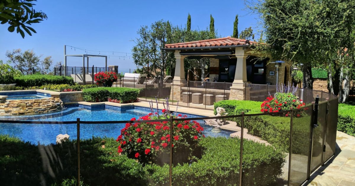 mesh black pool fence installed around swimming pool