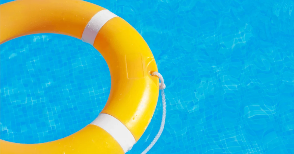 Yellow live saving buoy floating in a swimming pool