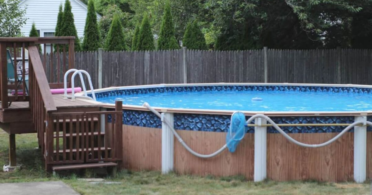 above ground pool with a small elevated wooden deck
