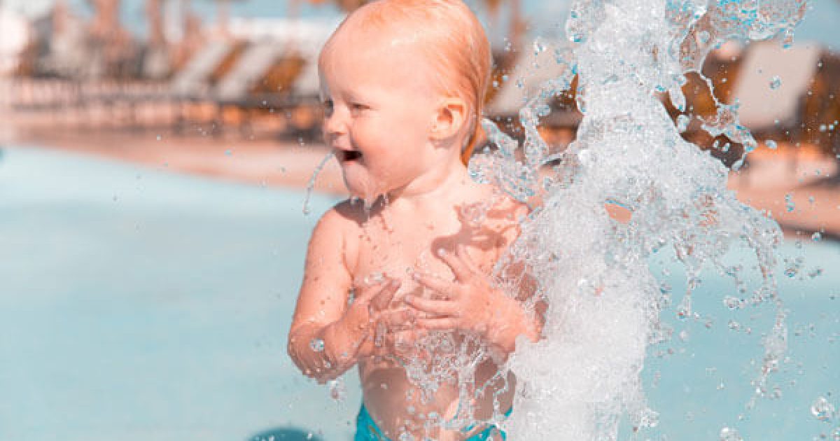 baby splashing in pool