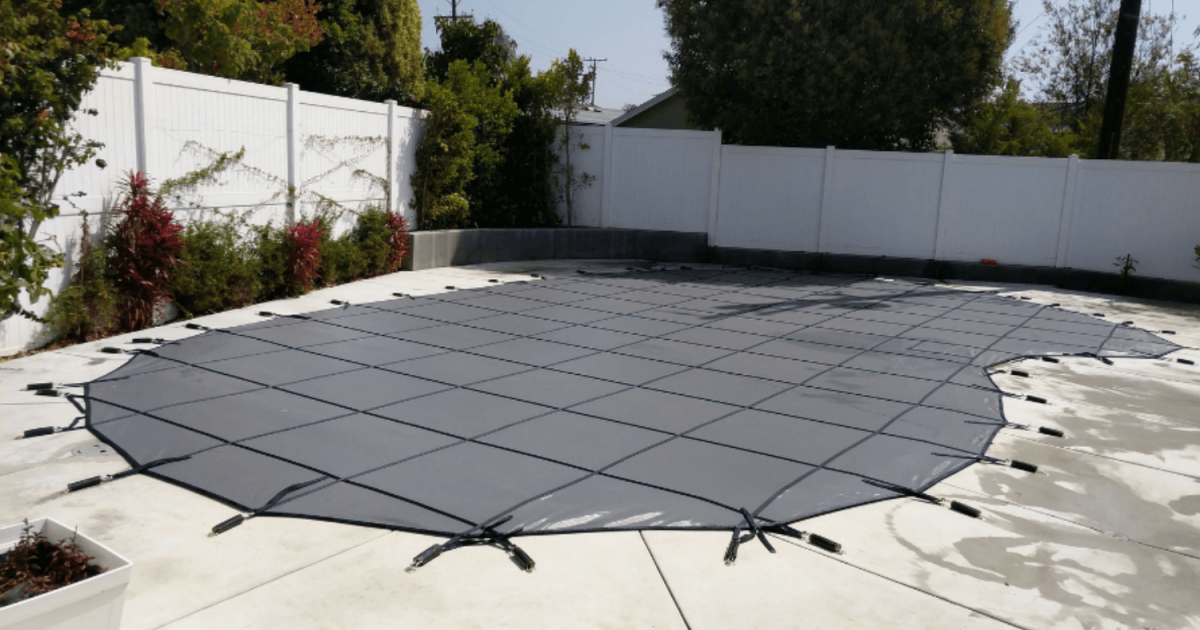 Black All-Safe winter pool cover installed