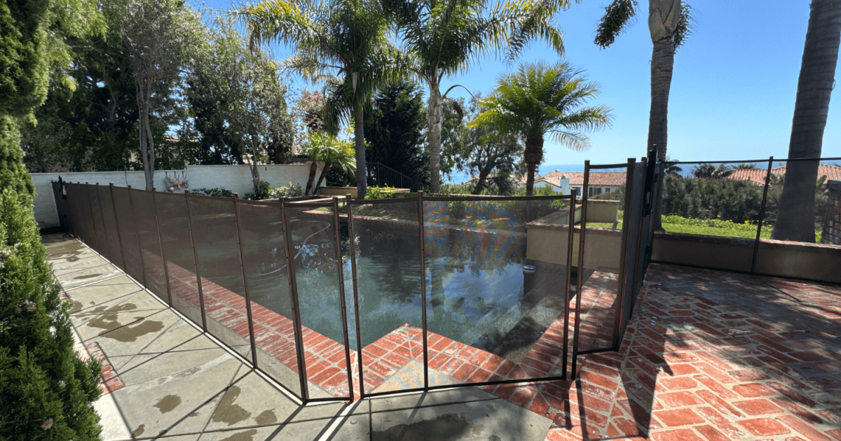 brown mesh pool fence installed around a pool