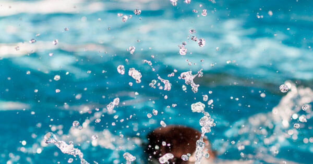 child jumping into water