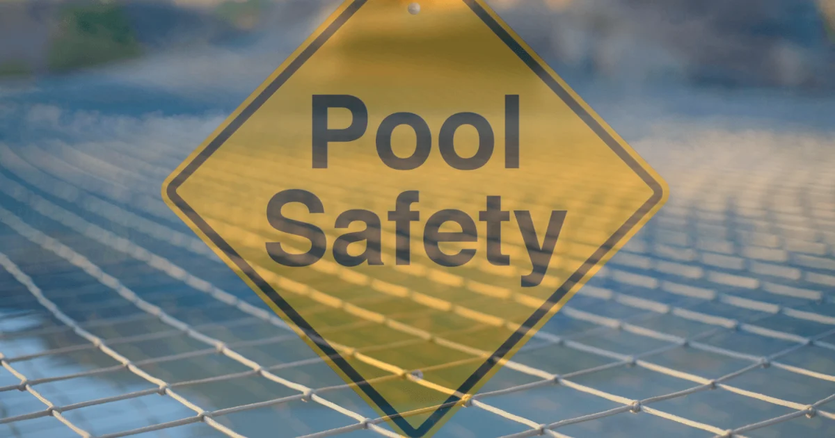 Faded out pool safety sign with safety pool netting over a pool in the background.