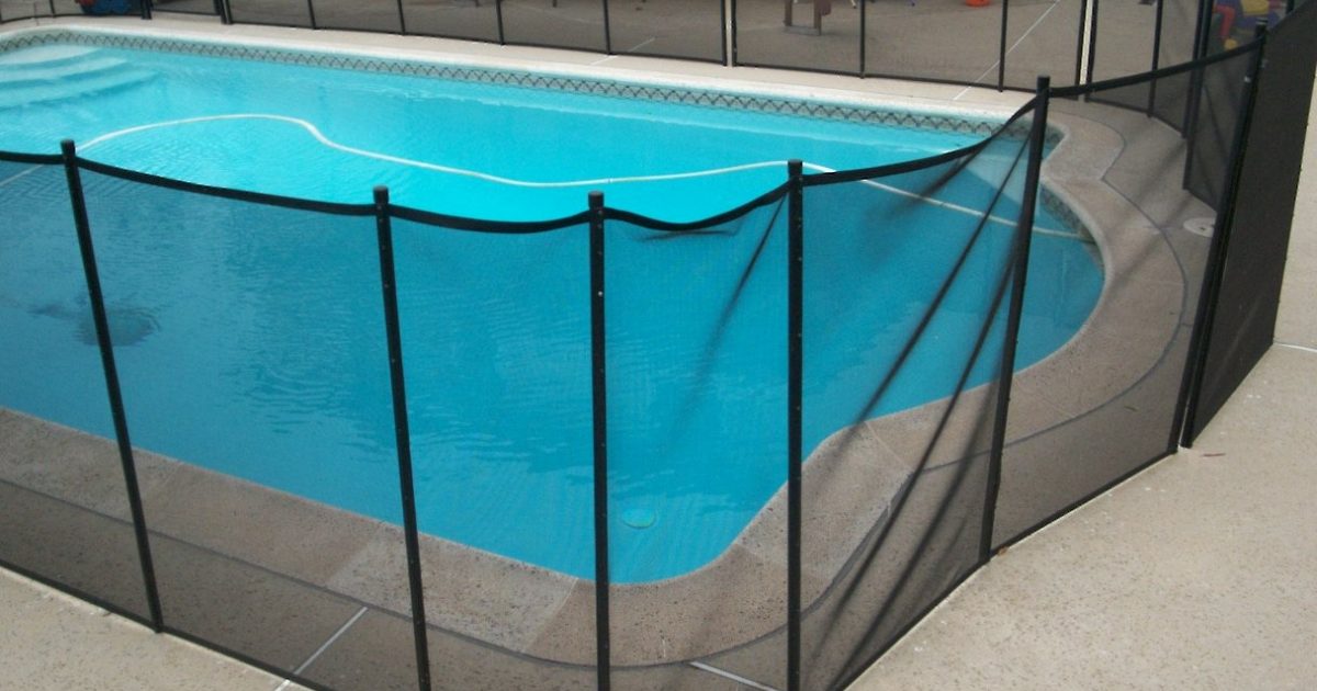 black mesh pool fence surrounding a swimming pool that was poorly installed by a DIYer