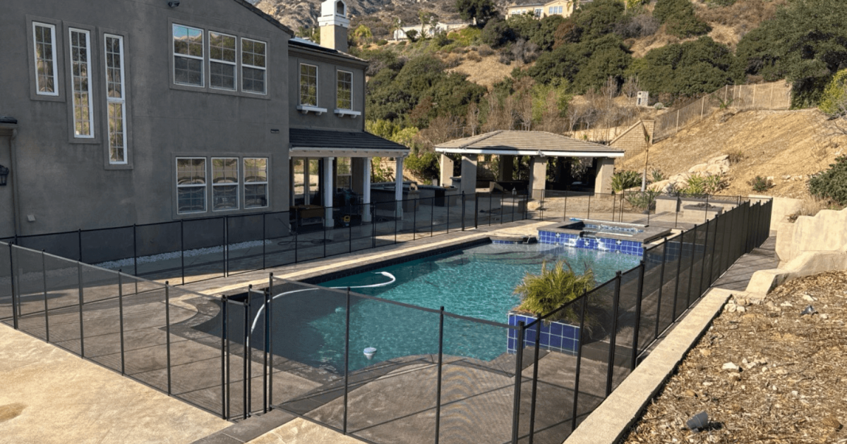 large home with a backyard pool that has a removable pool fence installed