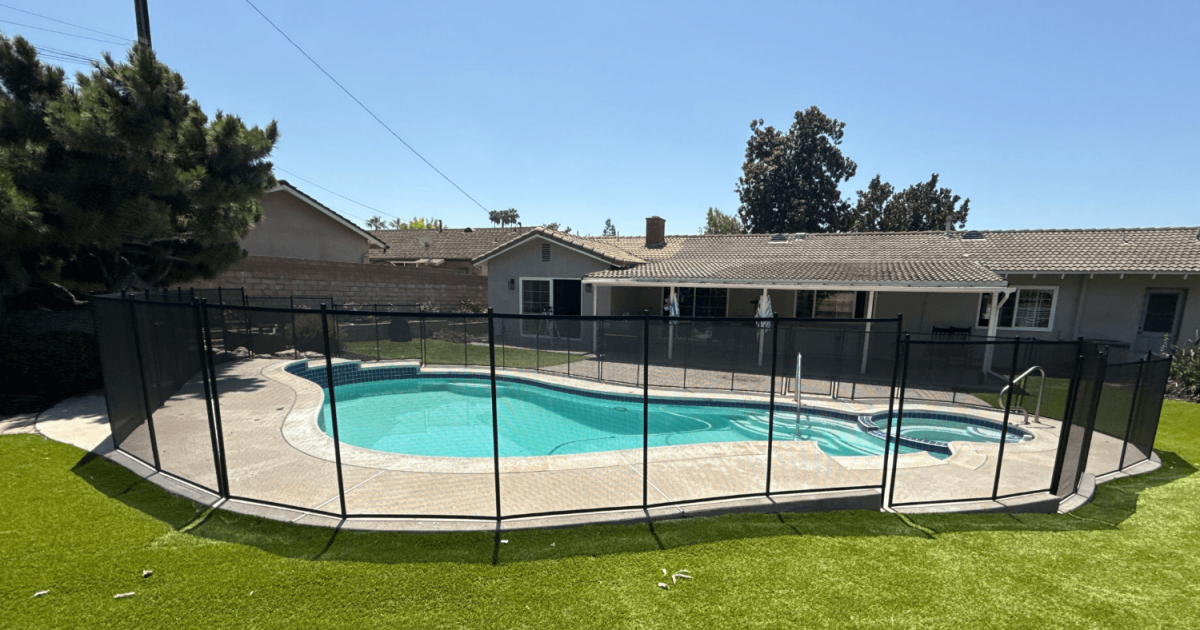 All-Safe black mesh removable pool fence installed around an irregular shaped pool