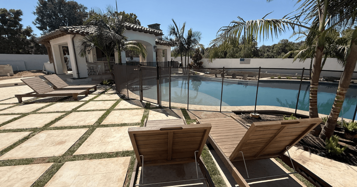 large backyard with swimming pool and lounge chairs