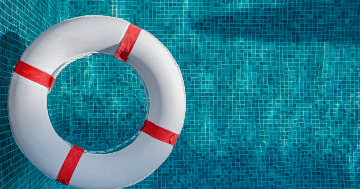 white and red pool flotation aid floating in a swimming pool