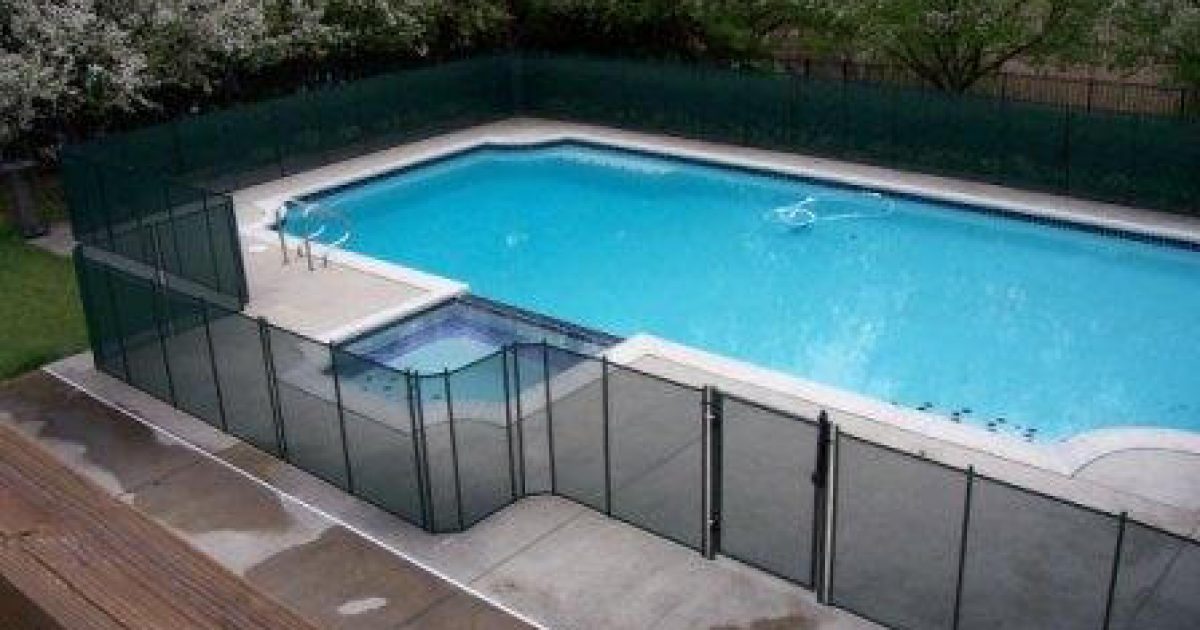 black removable mesh pool fence surrounding a pool and hot tub