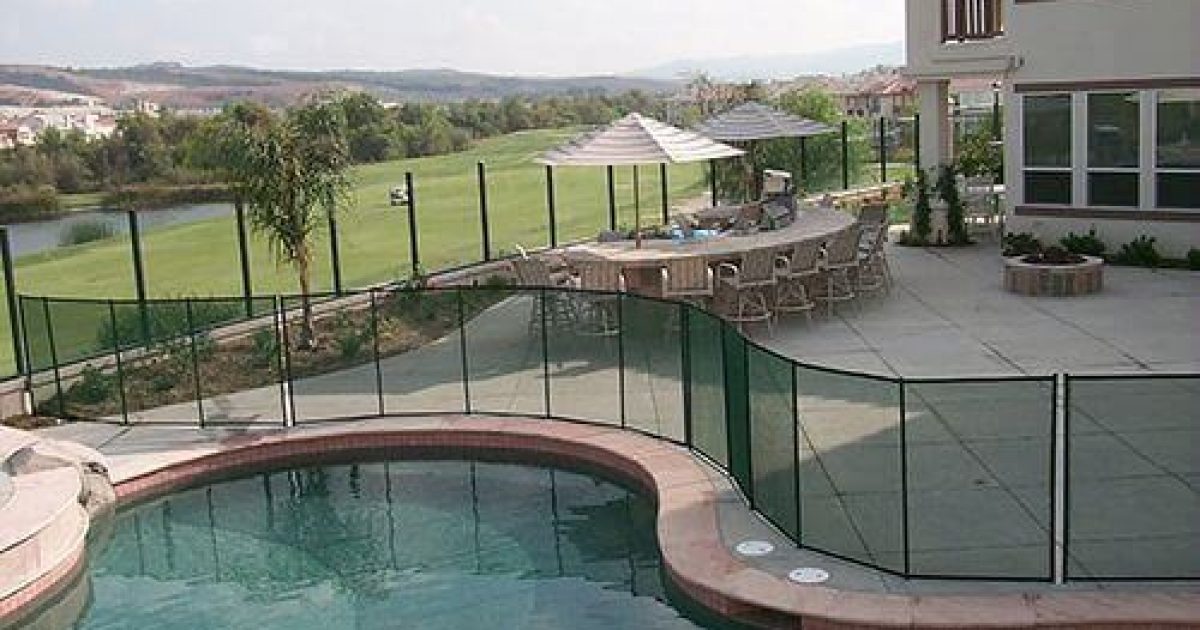black swimming pool fence surrounding an irregular pool