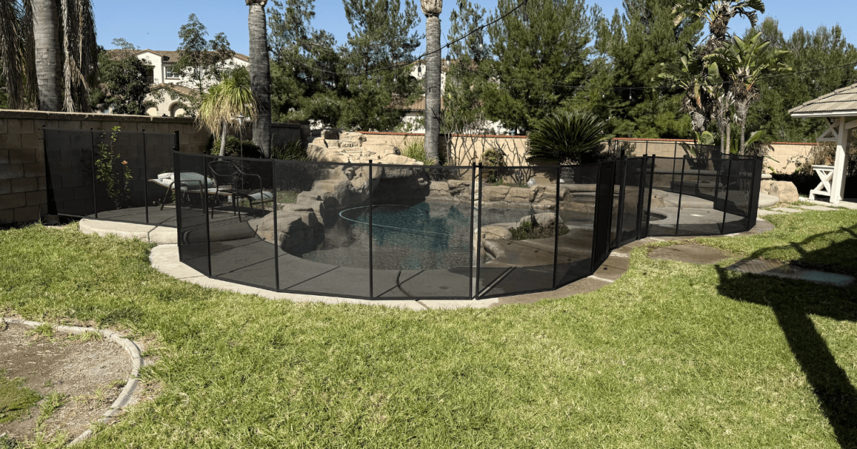 beautiful backyard with a black removable pool fence installed