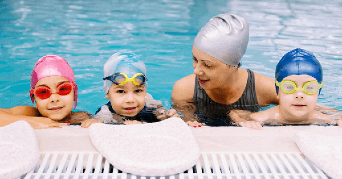 Kids in the pool with their swim instructor